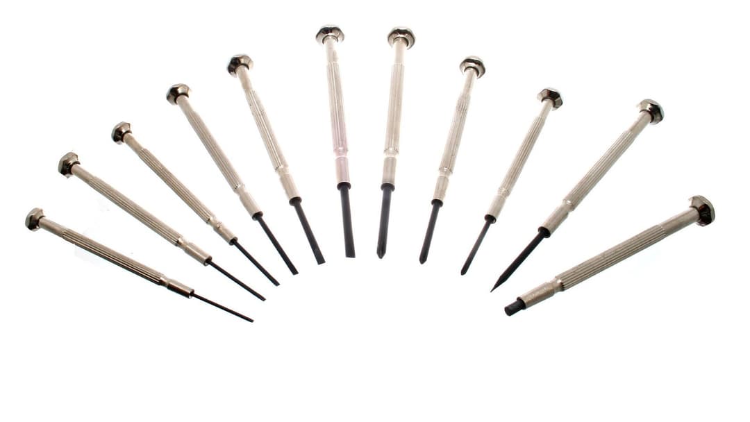 A set of small precision screwdrivers fanned out in a row on a plain white background.