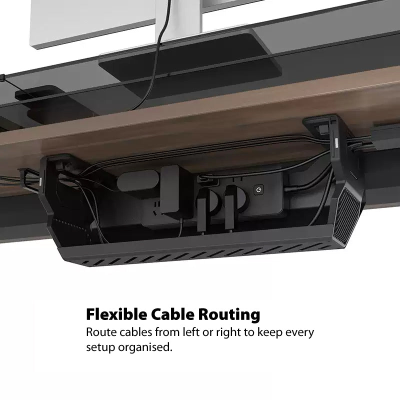 Under-desk cable management box showing flexible cable routing with a power strip and cables neatly organised beneath a desk