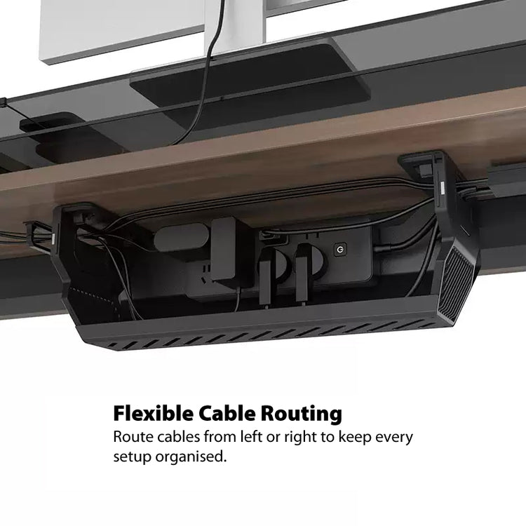 Under-desk cable management box showing flexible cable routing with a power strip and cables neatly organised beneath a desk